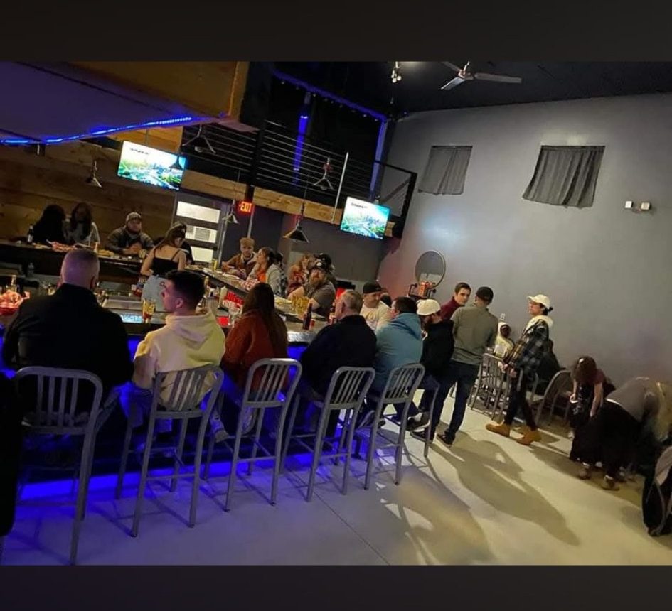 Bar seating under the blue lights at 6ers